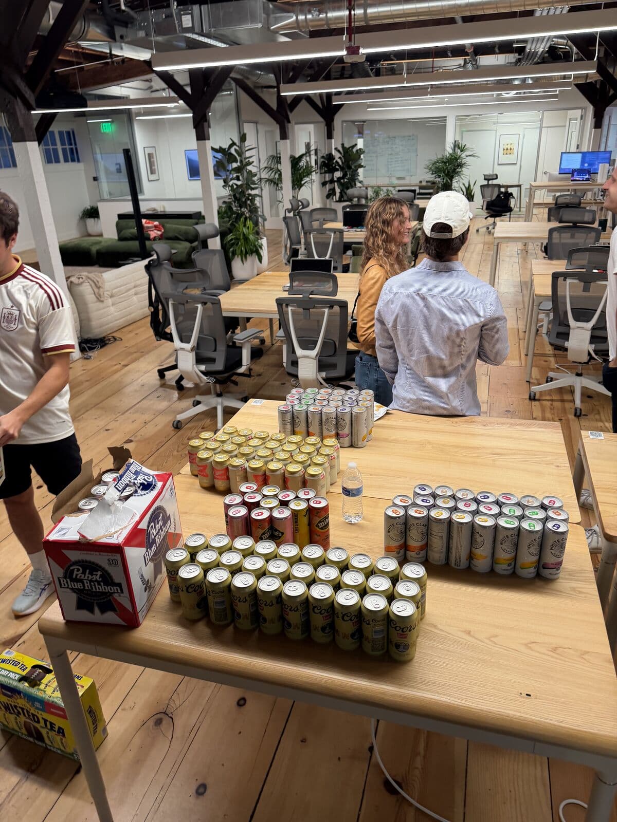 Rows of cans lined up on the drinks table