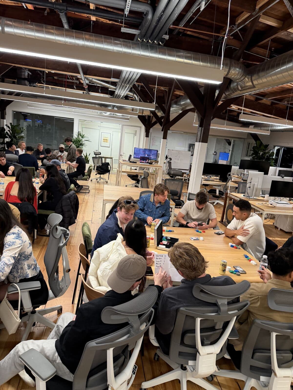 A table checking the chip-count sheet mid-game